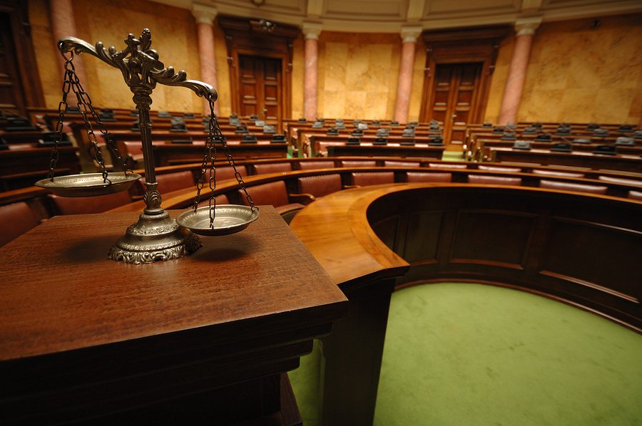 scales of justice in courtroom